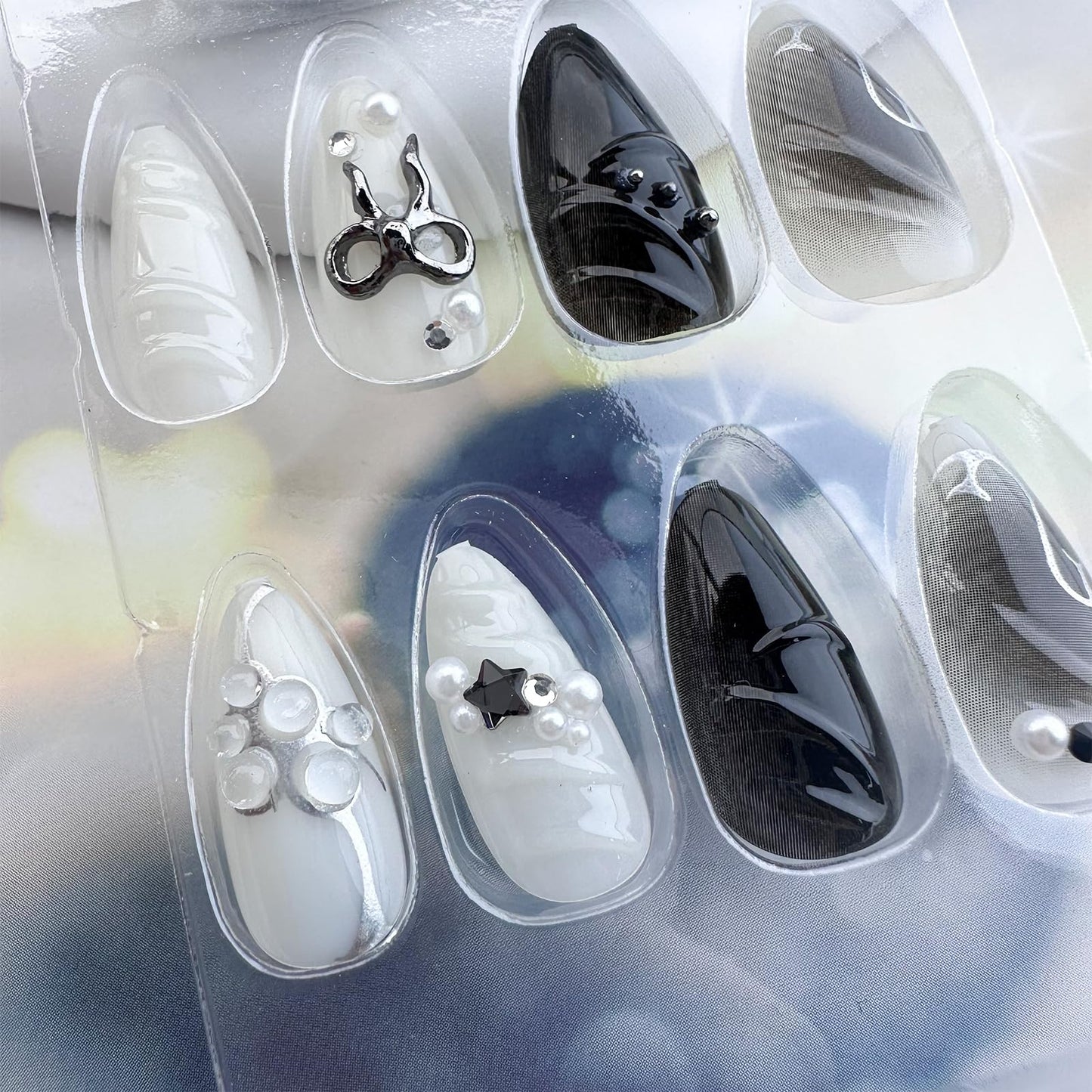 LBPEPAMZ Black Press on Nails Medium Almond Fake Nails with 3D Alloy Bow Pearl Designs Black Gradient Full Cover False Nail Water Drops Silver Star Glossy Acrylic Nails Stick on Nail for Women 24Pcs