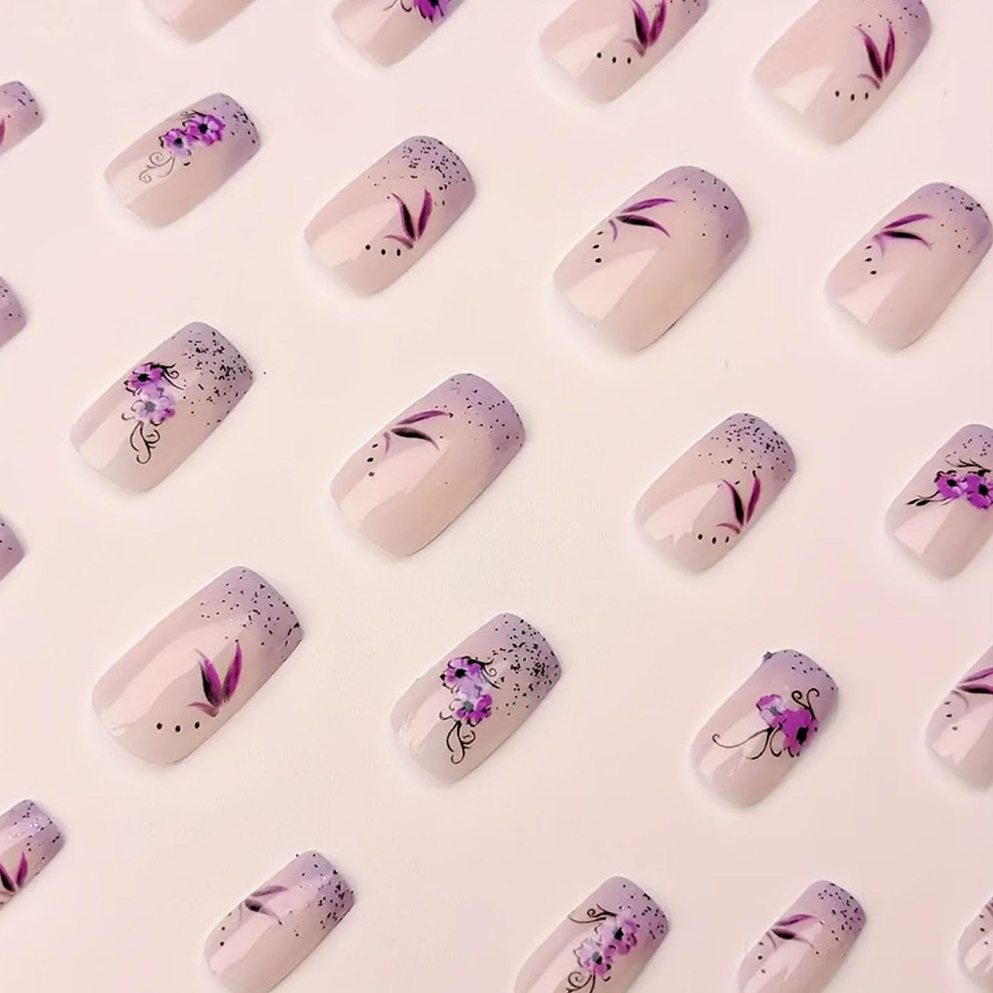 French Press on Nails Medium Short Fake Nails with Glitter Designs Purple Flowers Glue on Nails Translucent Nails Press ons Spring False Nails for Women 24 Pcs