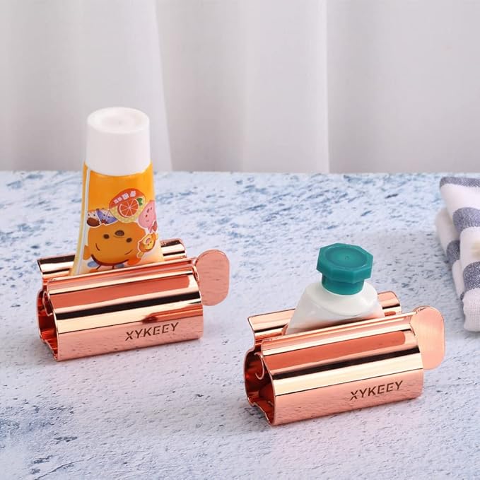 XYKEEY Toothpaste Tube Squeezer - Set of 2 Toothpaste Squeezer Rollers, Metal Toothpaste Tube Wringer Seat Holder Stand (Coral)