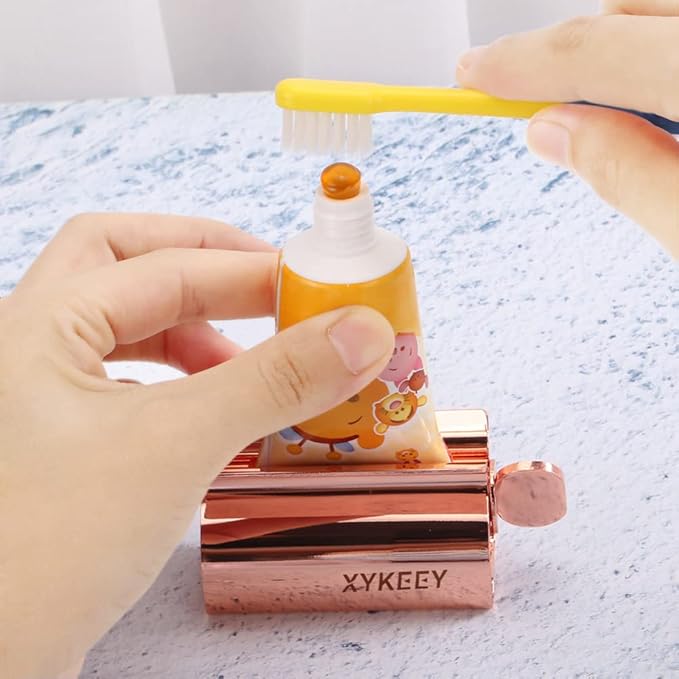 XYKEEY Toothpaste Tube Squeezer - Set of 2 Toothpaste Squeezer Rollers, Metal Toothpaste Tube Wringer Seat Holder Stand (Coral)