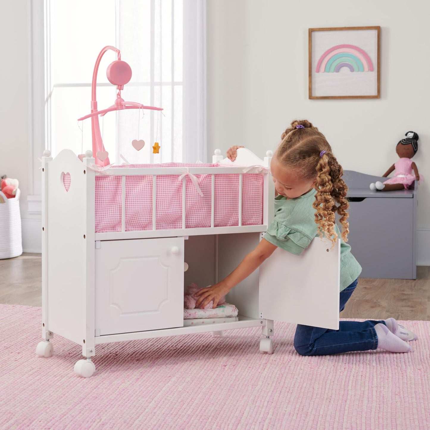 Badger Basket Wooden Toy Doll Bed with Storage, Mobile, and Bedding to Pretend and Play - Includes Wheels and Free Personalization Kit - White with Pink Gingham Fabric