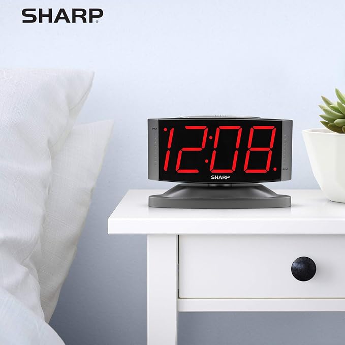 Sharp Outlet-Powered Alarm Clock with Swivel Base, Red LED, Gunmetal Grey | Large red LED digits; Adjustable swivel base; Brightness dimmer; Snooze alarm; Simple controls; Outlet powered