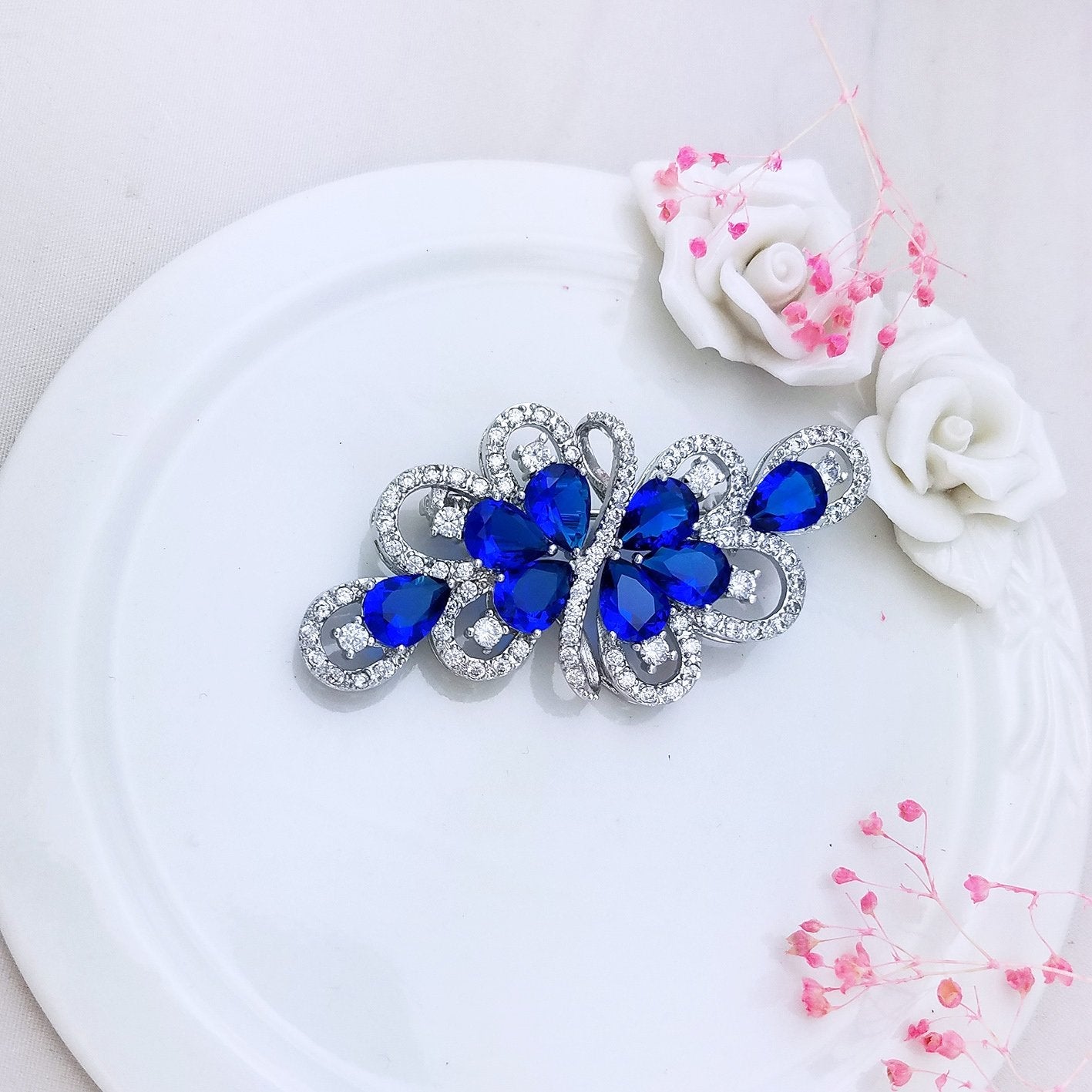 YOQUCOL Luxury Cubic Zirconia Crystal Rhinestone Dark Blue Stone Ribbon Shape Silver Tone Brooch Pin for Women