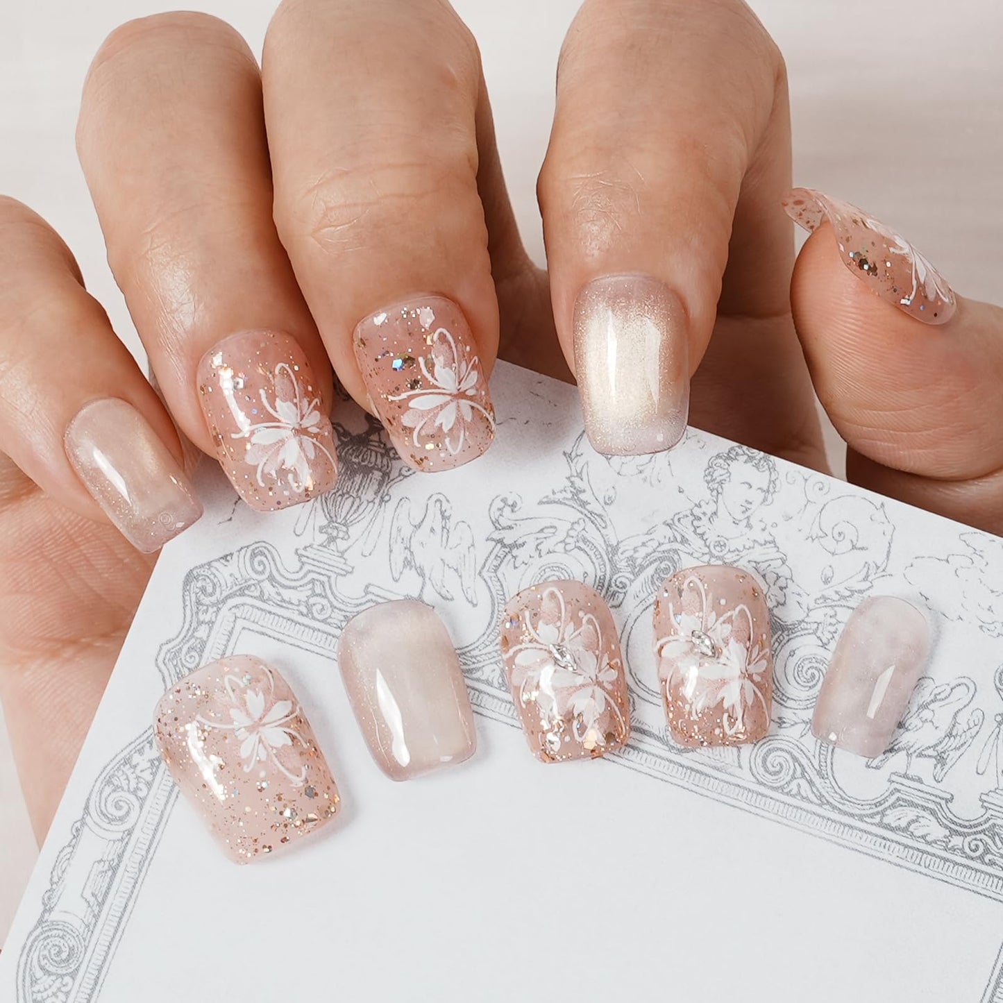 Tesytto Handmade Press on Nails Glitter Short Coffin, Nude Pink with Flower & Butterfly Pattern, Reusable Full Cover False Nails 10Pcs (Warm Glossy Dream,M)