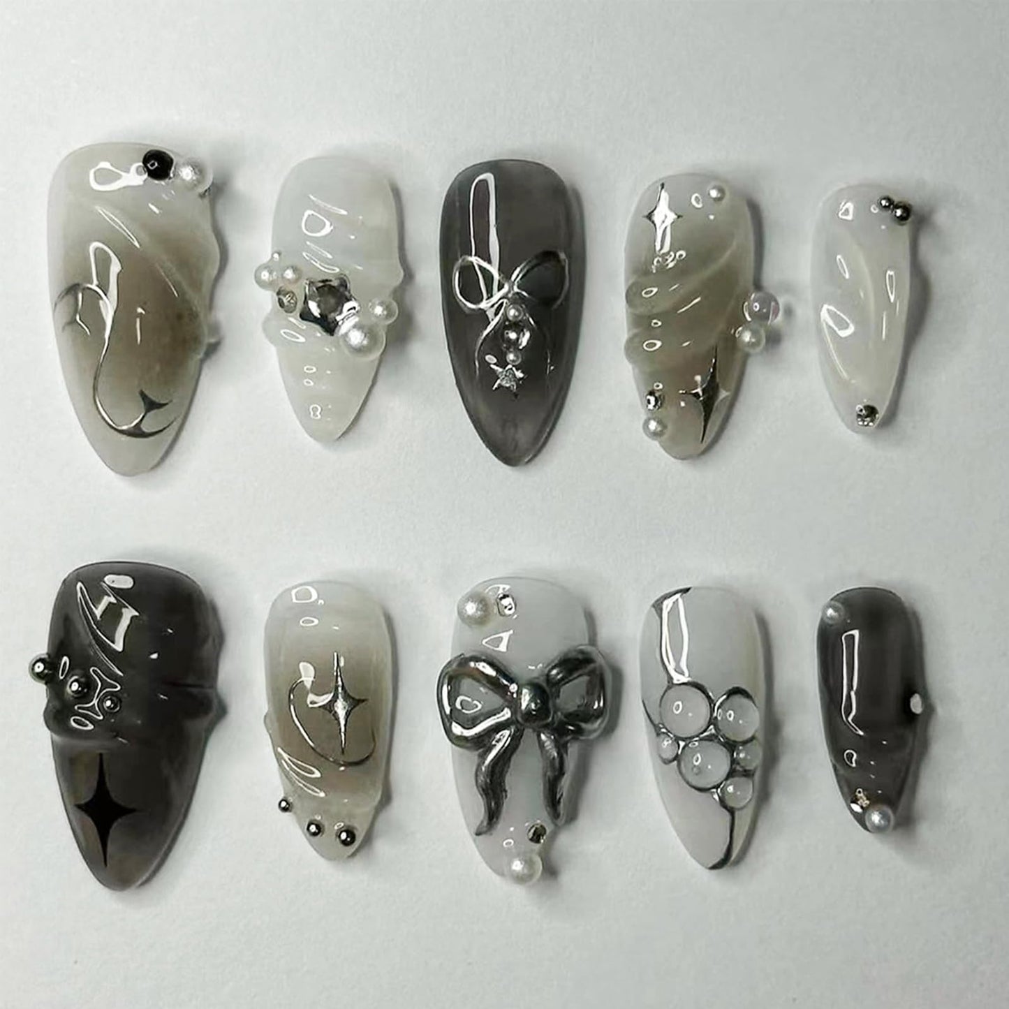 LBPEPAMZ Black Press on Nails Medium Almond Fake Nails with 3D Alloy Bow Pearl Designs Black Gradient Full Cover False Nail Water Drops Silver Star Glossy Acrylic Nails Stick on Nail for Women 24Pcs