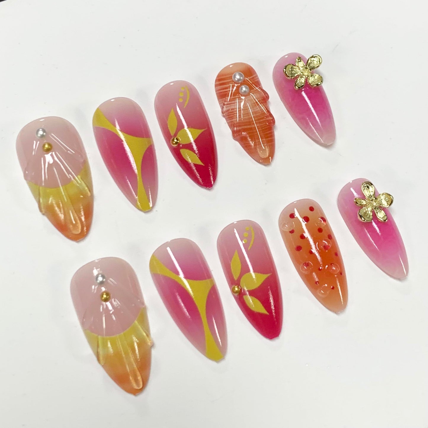 BABALAL Press On Nails, Medium Almond Fake Nails, Sunset Orange Pink Marble with Gold Flower Charm, Glossy Summer Tropical Glue On Nails for Women and Girls 24Pcs Reusable
