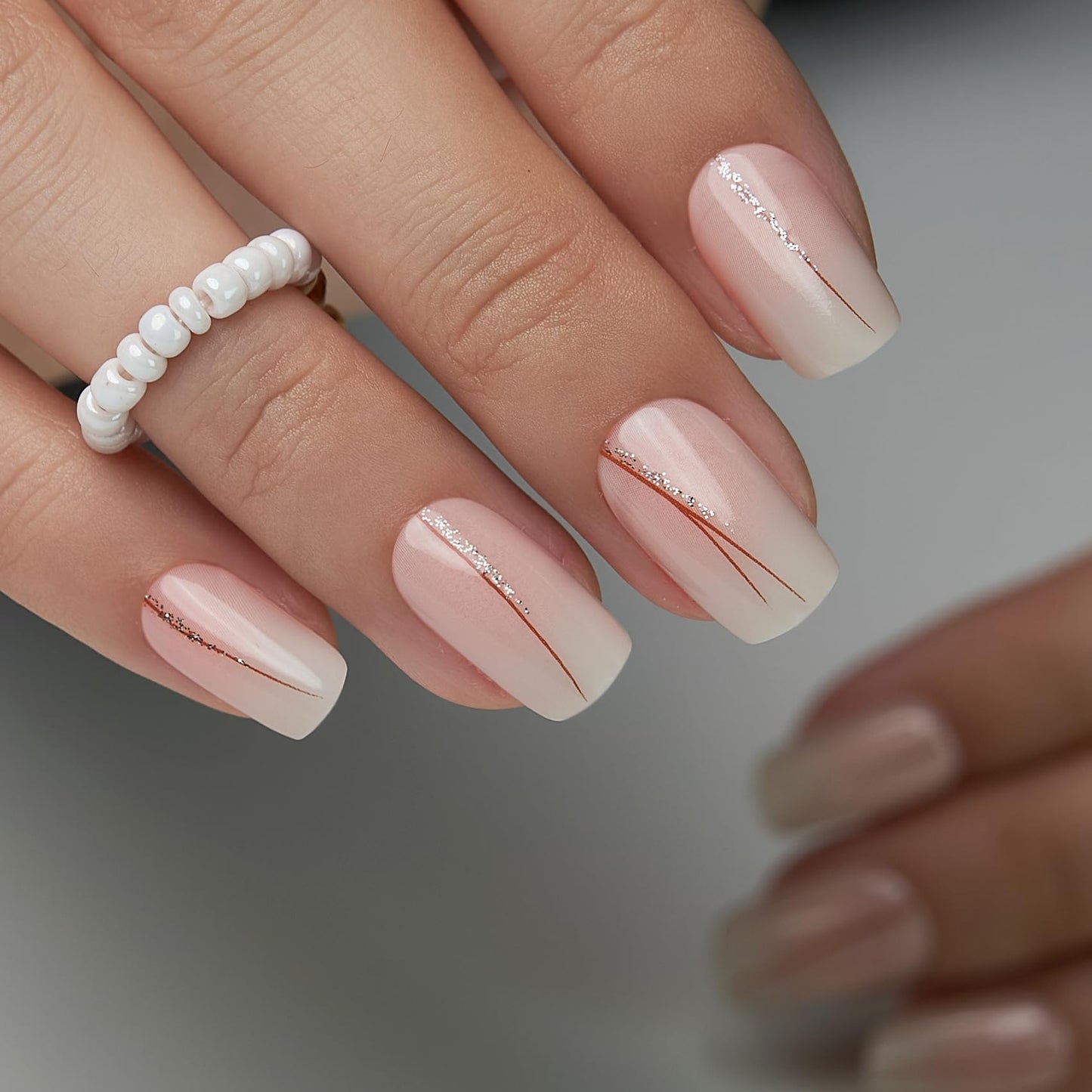 CurvLife Soft Gel Press On Nails – Reusable False Natural Fit Fake Nails Tips Stick Ons, Salon Quality UV Finish (Nude Nails with Glitter Lines, Medium)