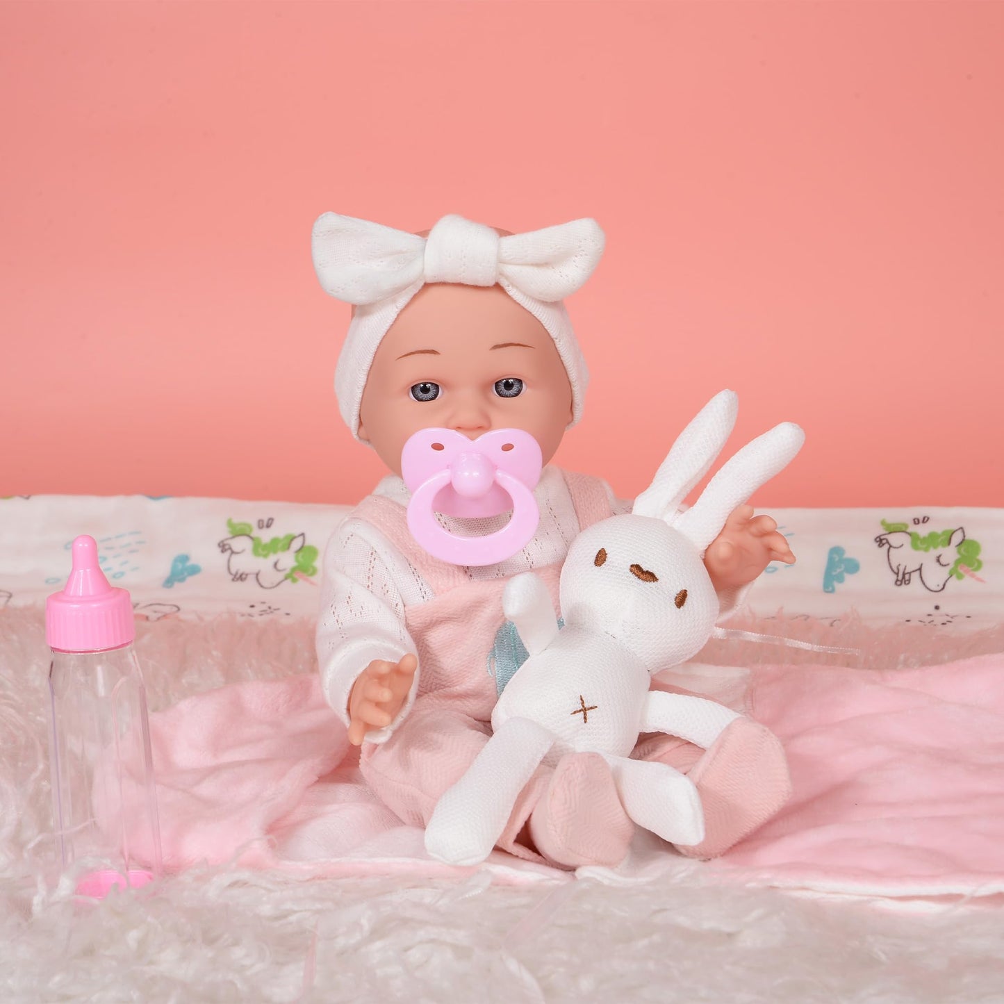 dollbie 12 inch Baby Doll - Adorable Doll and Accessories Including Romper, Sleeping Bag, Feeding Accessories, Rabbit Plush Toy