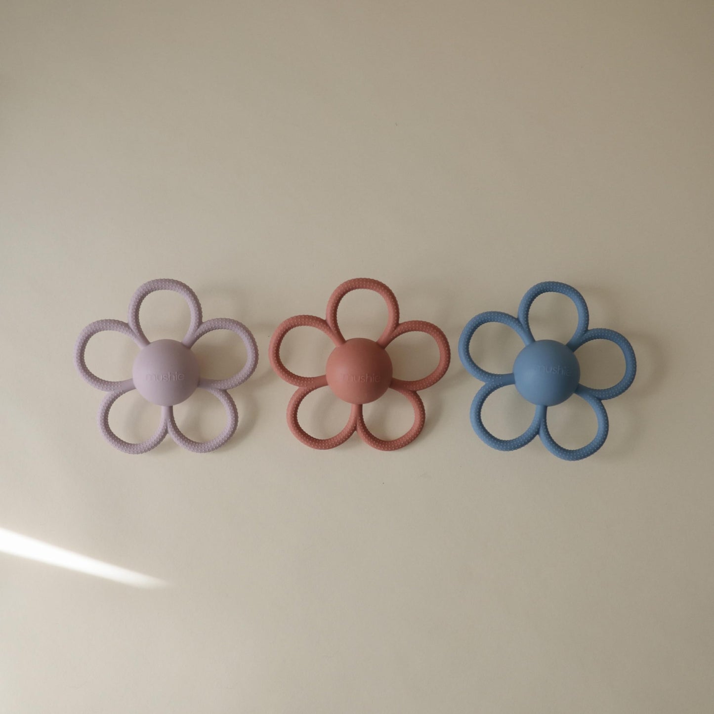 mushie Silicone Baby Daisy Rattle Teether Toy (Soft Lilac)