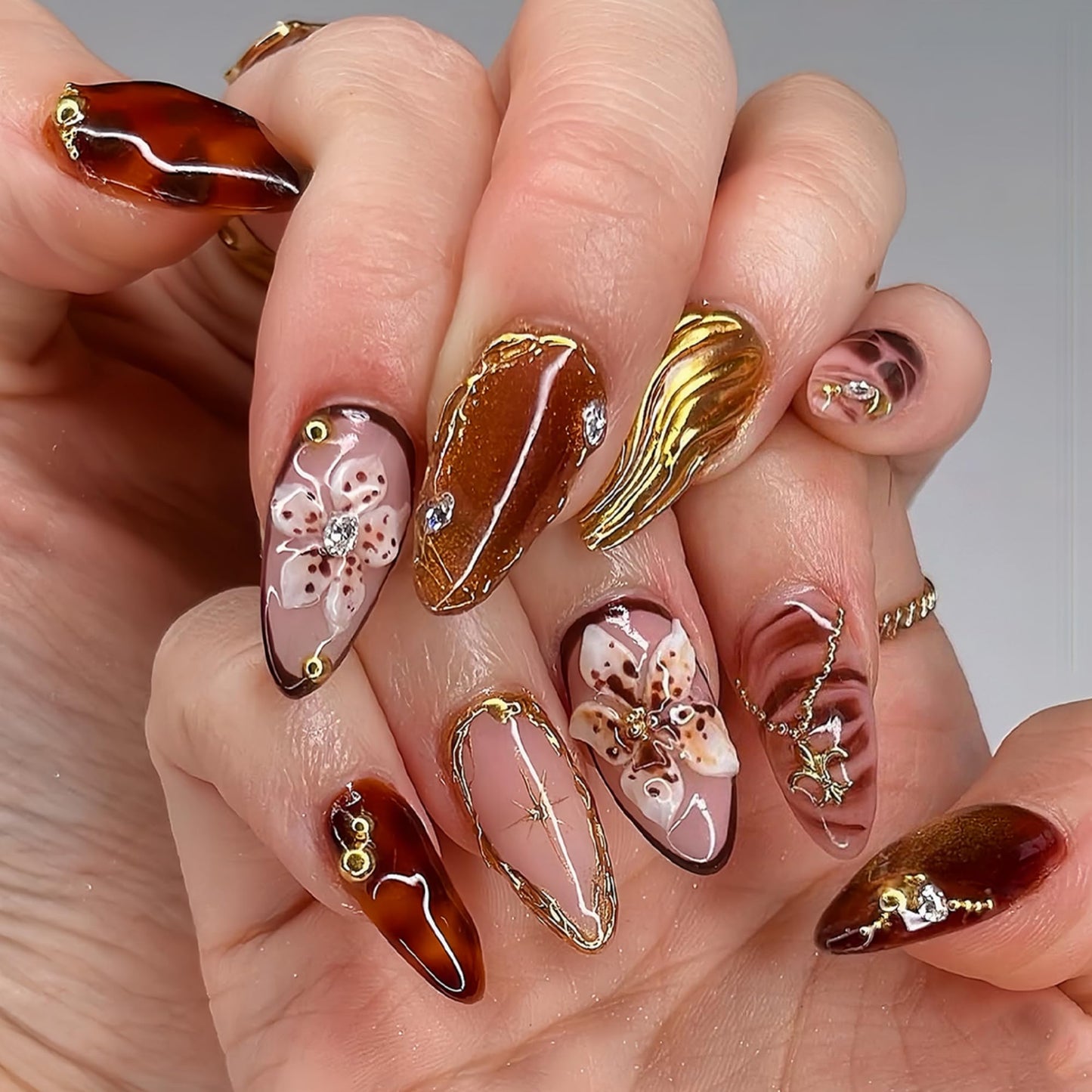 SEENEEY Medium Almond Press on Nails Brown Fake Nails Floral Artificial Nail with Gold Charm Designs Glitter Stick on Nail for Women 24pcs