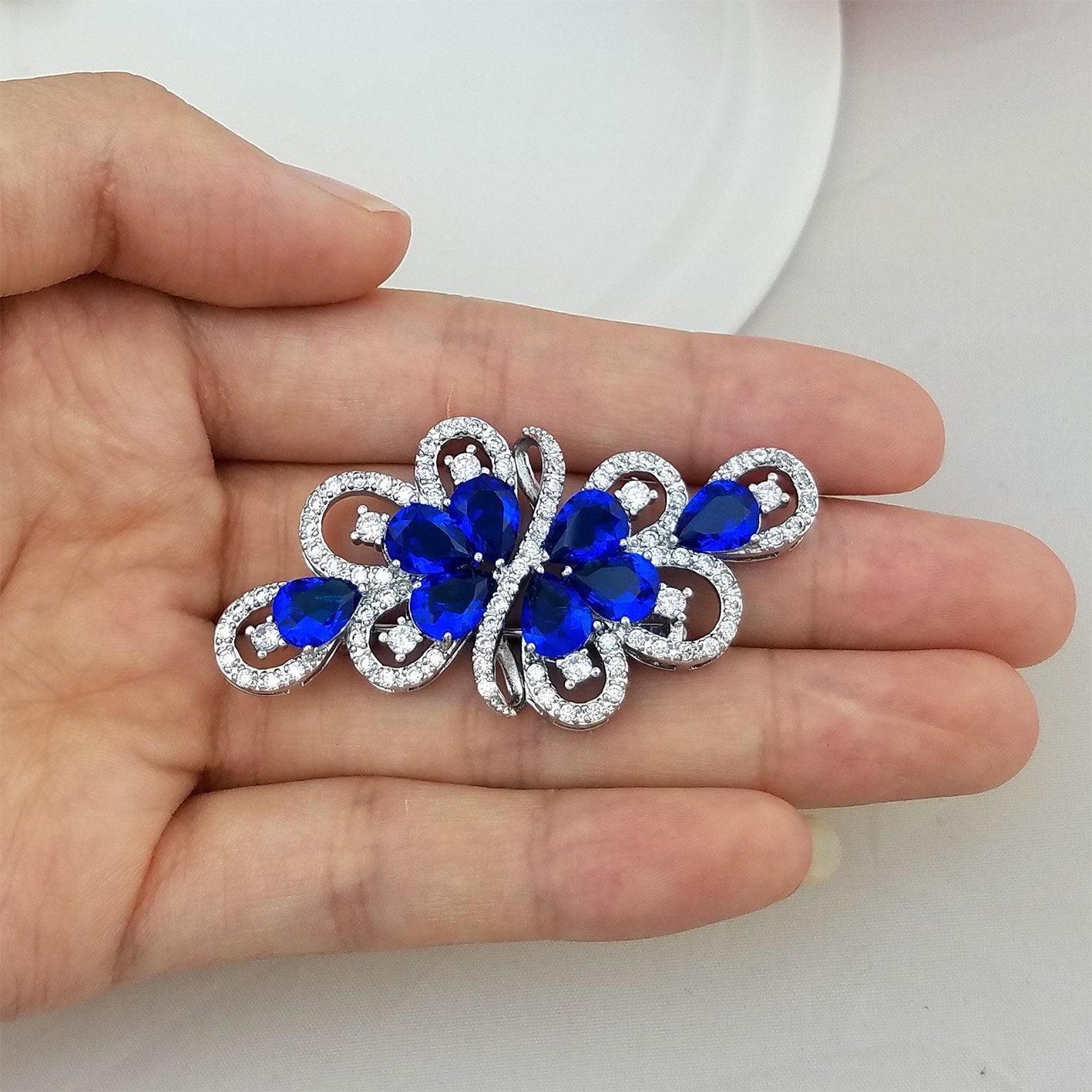 YOQUCOL Luxury Cubic Zirconia Crystal Rhinestone Dark Blue Stone Ribbon Shape Silver Tone Brooch Pin for Women