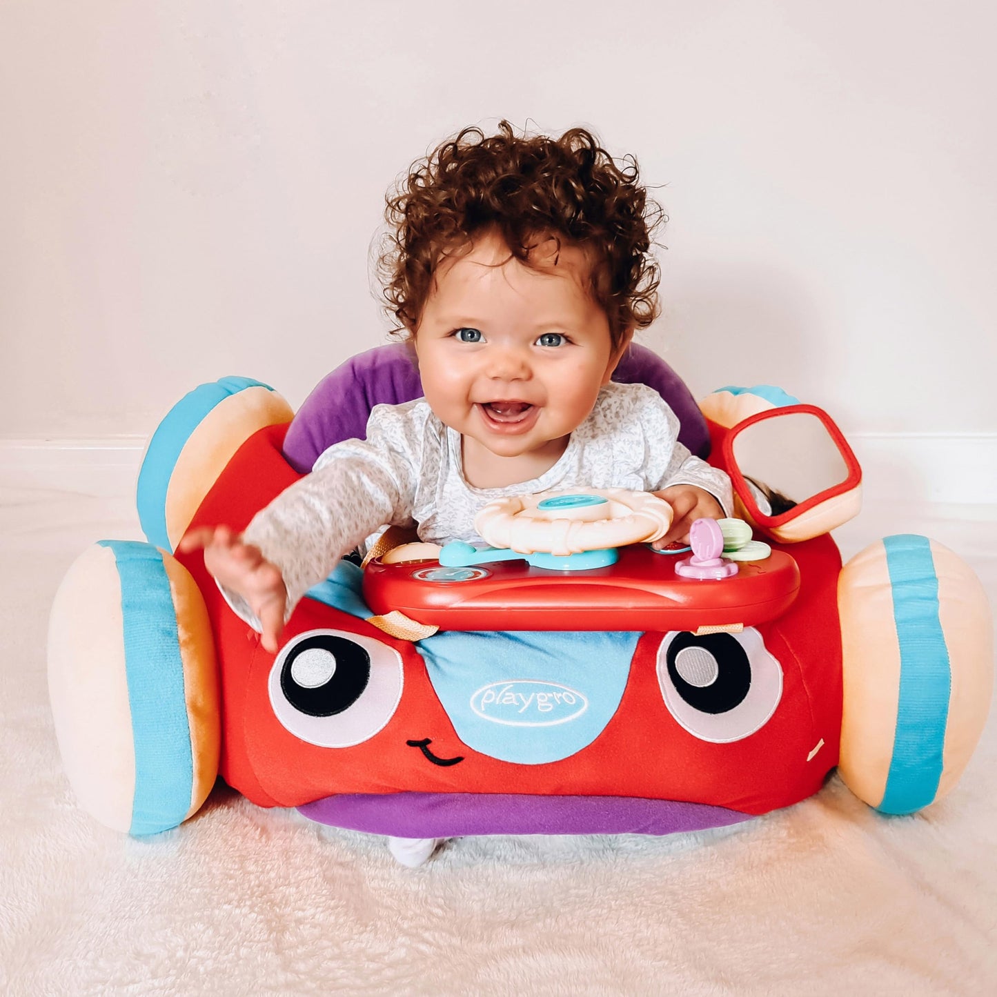 Playgro Music and Lights Comfy Car for Babies 6+ Months - Interactive Toddler Ride-On Toy for Imaginative Adventures - Detachable Dashboard, Storage Pouch, & Safe Play Space
