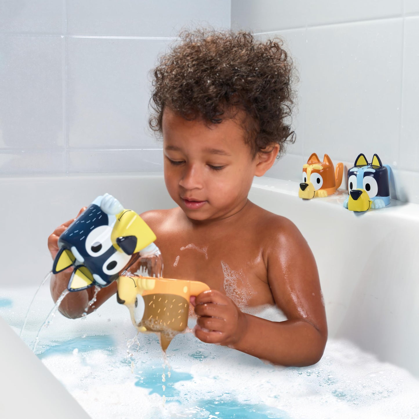 TOMY Toomies Bluey Bath Toys - Bluey's Family Pourers - Includes Chilli, Bandit, Bingo and Bluey Figures - Nesting and Stacking Cups for Bath, Beach or Pool - 4 Count - Ages 18 Months and Up