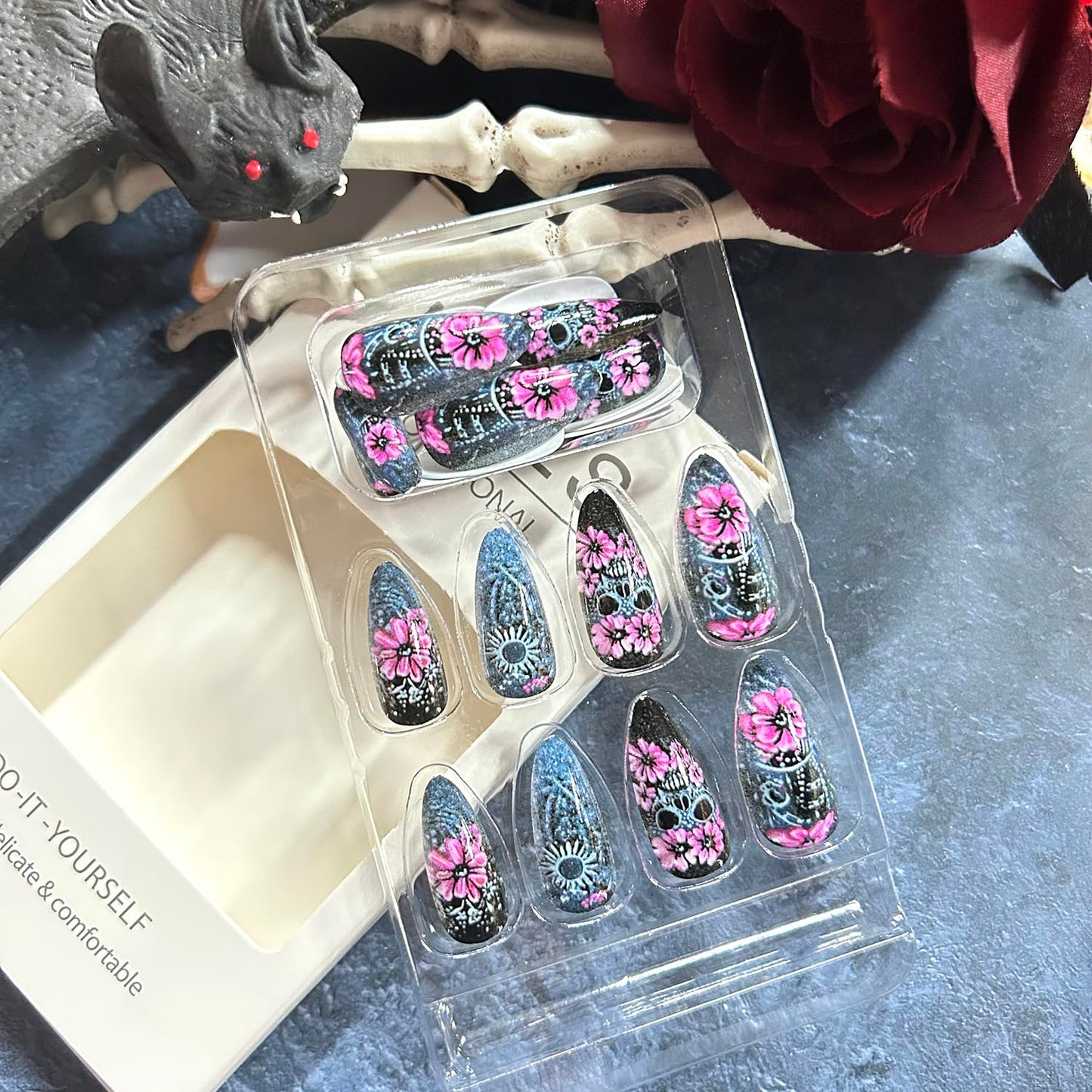 CJDLTS 24Pcs Halloween Flower Skull Press on Nails Medium Pink Floral Skull Pattern Design Halloween Nail Full Cover Glossy Artificial Acrylic False Nail French Almond Medium Glue on Nails for Women